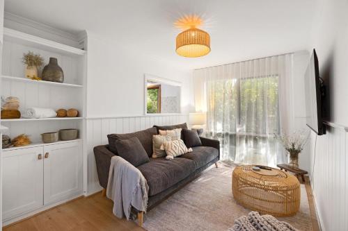 a living room with a couch and a table at Cooinda Inverloch in Inverloch