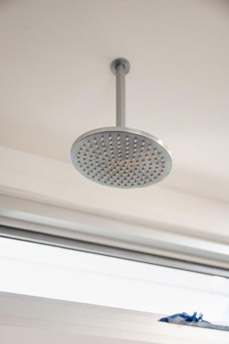 a light hanging from a ceiling in a room at Haven Views Harmers Haven in Cape Paterson
