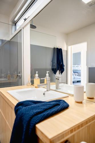 a bathroom with a sink and a large mirror at Haven Views Harmers Haven in Cape Paterson