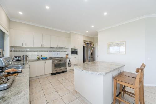 a kitchen with white cabinets and a counter top at Waterview Inverloch in Inverloch