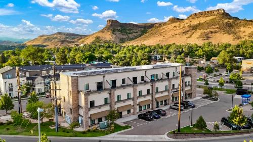 an apartment building with a mountain in the background at Golden Condo Patio with MTN Views Walk to DT Golden and School of Mines in Golden