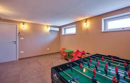 a room with a ping pong table and chairs at Cozy Home In Gornja Stubica With Sauna in Gornja Stubica
