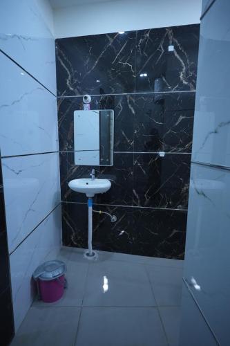 a bathroom with a sink and a mirror on the wall at preferred hotel and restaurant in Roorkee