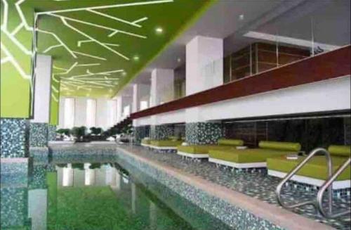 a building with a swimming pool with green and white at Nomade Place in Heart of new Polanco/ 4guest in Mexico City