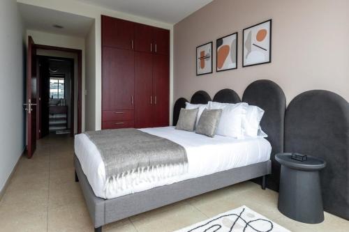 a bedroom with a large bed with a large headboard at Nomade Place in Heart of new Polanco/ 4guest in Mexico City