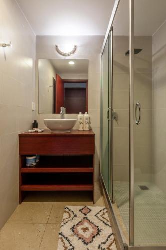 a bathroom with a sink and a glass shower at Nomade Place in Heart of new Polanco/ 4guest in Mexico City