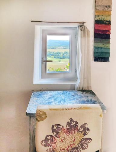 a window with a table in front of it at Maisonnette provençale in Simiane-la-Rotonde