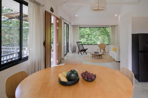a dining room table with a bowl of fruit on it at Boonya Swiss Home in Chaloklum