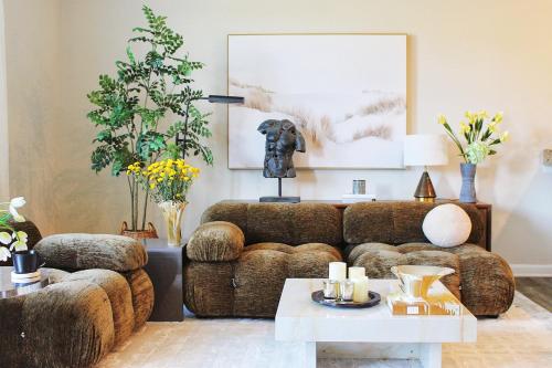 a living room with a couch and a table at Mountain Whispers - Modern Chic Near Shenandoah National Park in Luray
