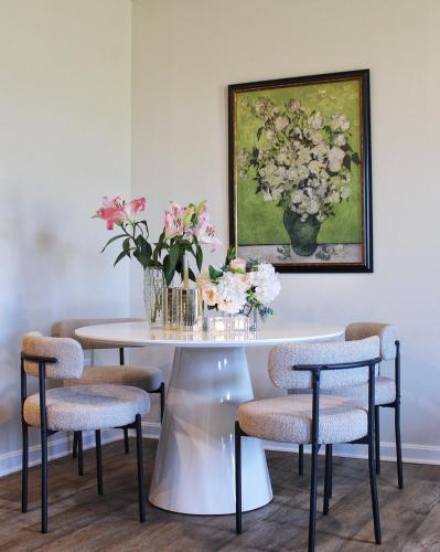 a table with chairs and a vase of flowers on it at Mountain Whispers - Modern Chic Near Shenandoah National Park in Luray