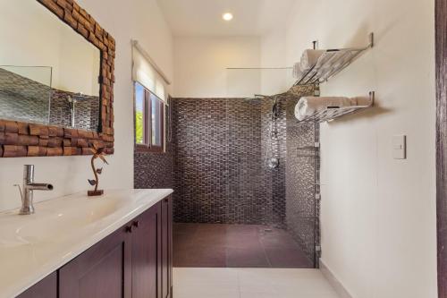 a bathroom with a shower and a sink at Casa Javi- Ocean Front located Mid Isla Mujeres in Isla Mujeres