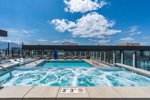 a swimming pool on the roof of a building at Downtown beauty-PoolHotTubGym-near SaltPalace-View in Salt Lake City