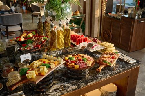 a buffet with many different types of food on a counter at CLASSYC Hotel in Hanoi