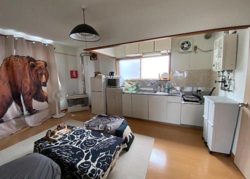 a kitchen with a bed in the middle of a room at Bear Foot東町 in Yakumo