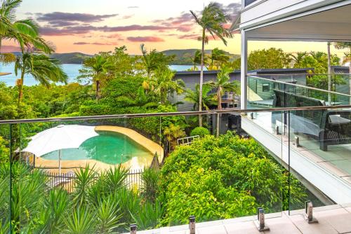 an outdoor balcony of a house with a swimming pool at Oasis Apartments on Hamilton Island by HIHA in Hamilton Island