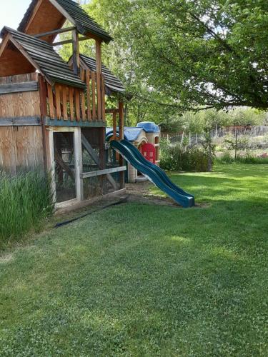 a playground with a slide in a yard at Starlight Gardens in Henrieville