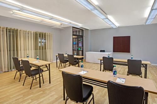 a conference room with tables and chairs and a podium at Wyndham Garden Norfolk Downtown in Norfolk