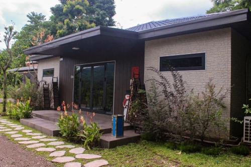 a small house with a pathway in front of it at Halo Retreat in Hòa Bình