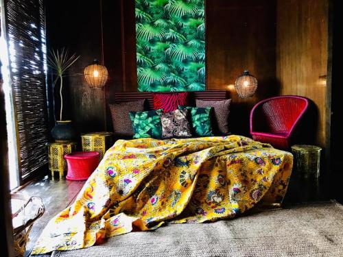 a bedroom with a bed with a colorful blanket at Turtle Hill Patnem in Canacona