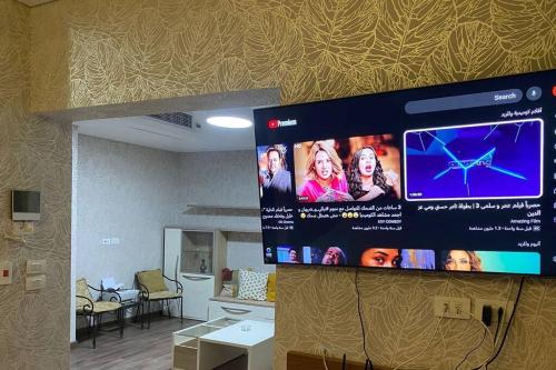 a projection screen on a wall in a room at Elegant 3-Floor Villa with Private Garden in Westown, SODIC Beverly Hills, Sheikh Zayed in Sheikh Zayed