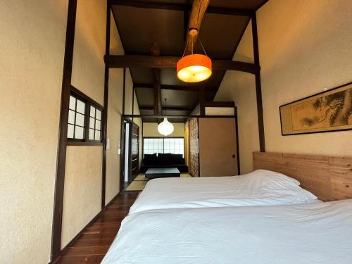 a bedroom with a large white bed in a room at 清水寺徒歩8分 一棟貸切 伝統的な京町家 in Keage
