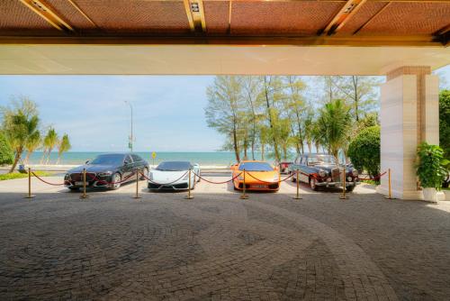 a group of three cars parked in a parking lot at DongHu Resort Hotel in Sihanoukville