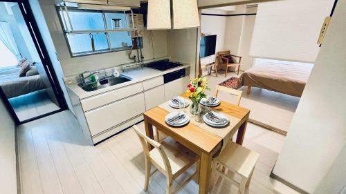 a small kitchen with a table in a small room at Shinjuku spacious apartment for max 8ppl in Tokyo