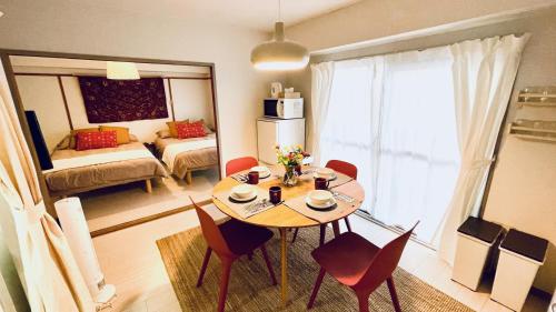 a room with a table and chairs and a living room at Shinjuku spacious apartment for max 8ppl in Tokyo