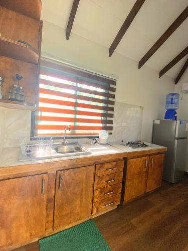 a kitchen with a sink and a window at Cabañas Keihana Rapa Nui in Hanga Roa