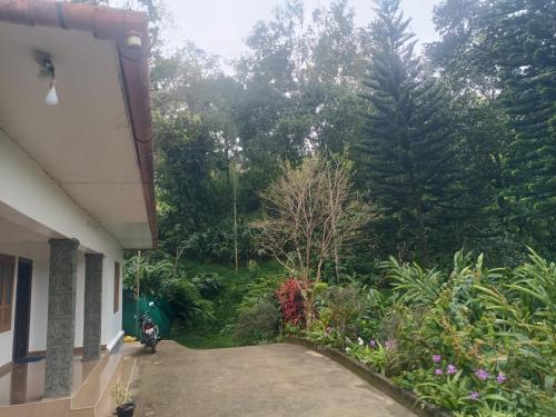 a view of a garden from the outside of a house at Anivilla Holiday Home Kunjithanny in Anachal
