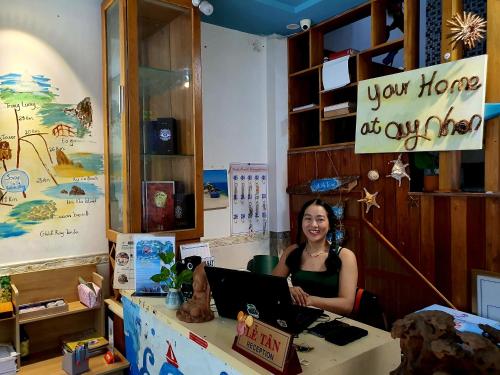 a woman sitting at a desk with a laptop at Sông Suối Homestay in Quy Nhon