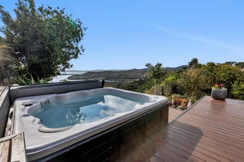 a hot tub sitting on top of a deck at Sunrise Lookout - Paihia Holiday Home in Haruru