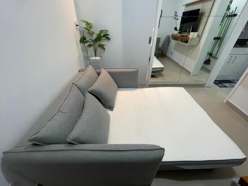 a couch with pillows sitting in a living room at Beautiful Copacabana Beach House na Quadra da Praia in Rio de Janeiro