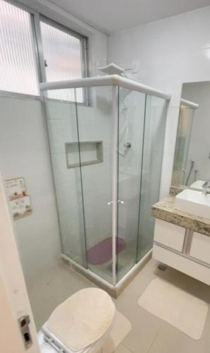 a bathroom with a glass shower and a sink at Beautiful Copacabana Beach House na Quadra da Praia in Rio de Janeiro
