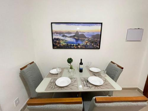 a dining room table with a white table and chairs at Beautiful Copacabana Beach House na Quadra da Praia in Rio de Janeiro