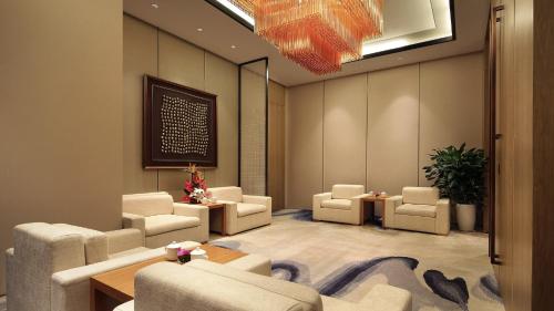a waiting room with couches and chairs and a table at Crowne Plaza Yibin by IHG in Yibin