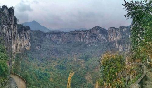 a view of a canyon with tall cliffs and trees at Crowne Plaza Yibin by IHG in Yibin