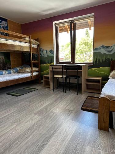 a bedroom with two bunk beds and a desk at ЛемГора in Vorokhta