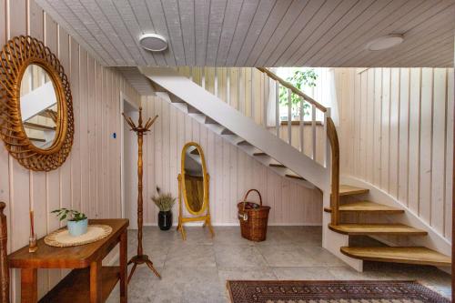 a room with a staircase and a mirror at Pušyno apartamentai in Druskininkai
