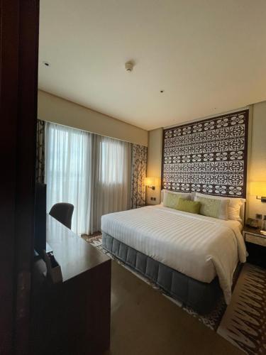 a bedroom with a large bed and a television at Dusit Thani Residence Executive Suite in Sasabayou