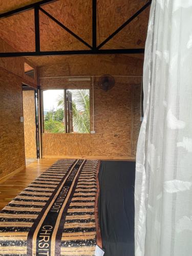 an empty bed in a room with a window at HOMESTAY ĐỐM HOUSE in Hoat