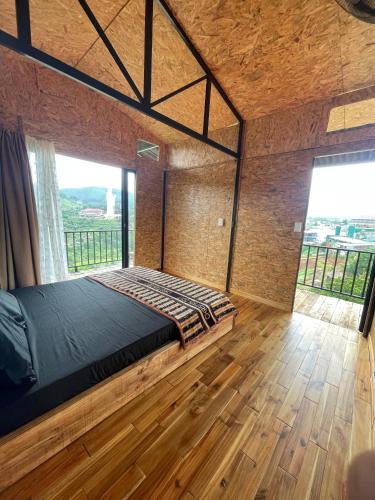 a bedroom with a large bed with a large window at HOMESTAY ĐỐM HOUSE in Hoat
