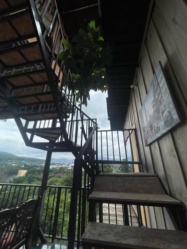 a set of stairs in a building with a view at HOMESTAY ĐỐM HOUSE in Hoat
