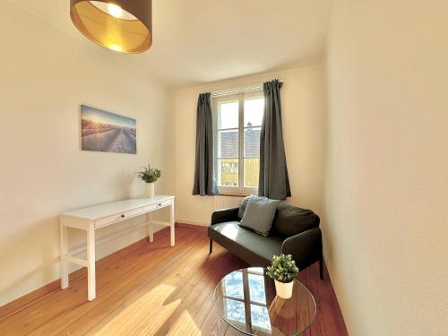a living room with a couch and a table at Business Apartment in Derendingen in Derendingen