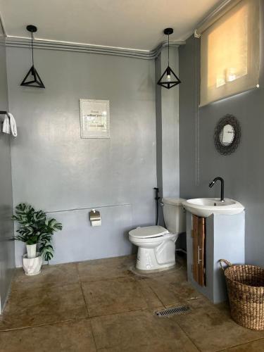 a bathroom with a toilet and a sink at Isla Del Antoño in Cavinti