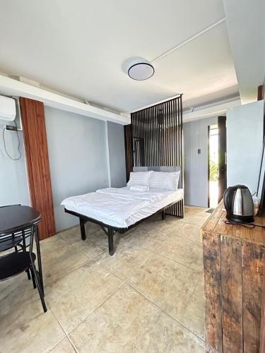 a bedroom with a bed in the middle of a room at Isla Del Antoño in Cavinti
