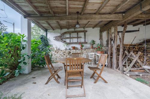 a wooden table and chairs on a patio at C Vilamide in Parada de Achas
