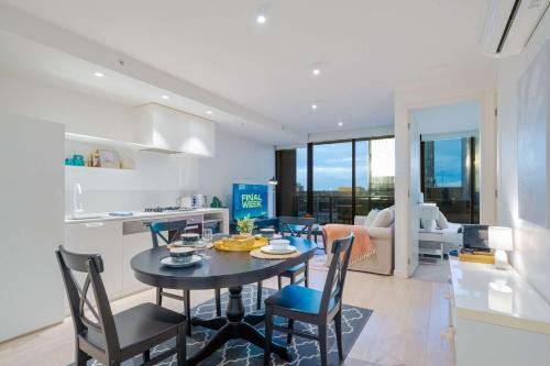 a kitchen and dining room with a table and chairs at Pride Manor South Yarra in Melbourne