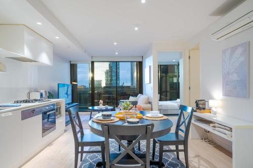 a kitchen and dining room with a table and chairs at Pride Manor South Yarra in Melbourne