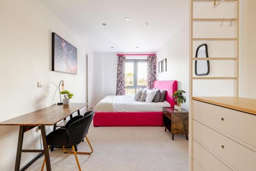 a bedroom with a bed and a desk and a desk at FMSS - City Luxe in London